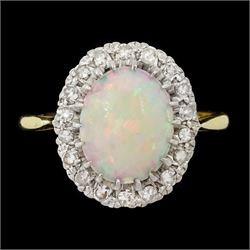 18ct gold opal and diamond cluster ring, single oval opal surrounded by eighteen single cu...