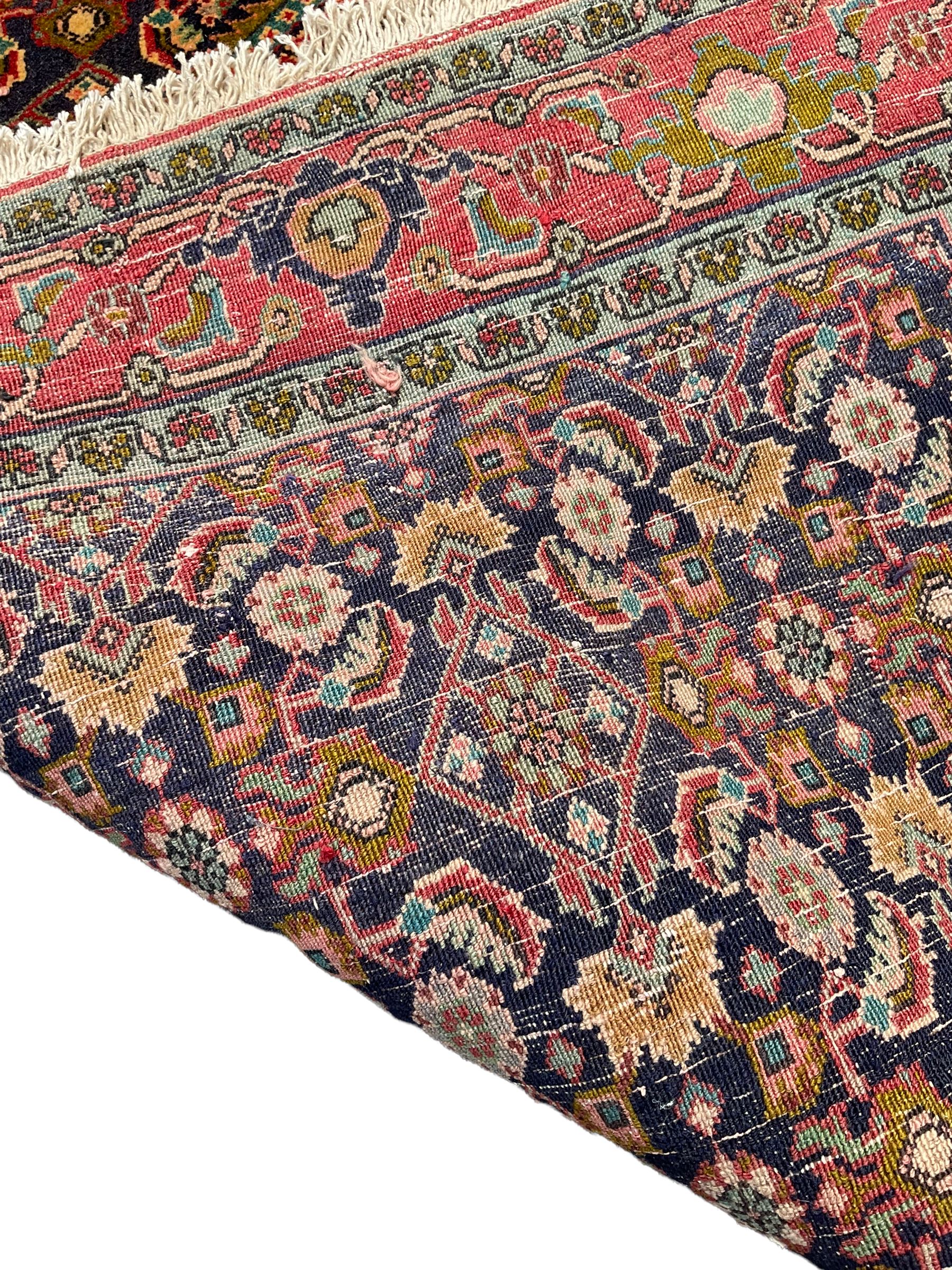 Persian Bijar red and blue ground rug, central panel decorated with tree of life and flower head motifs, decorated all-over with Herati motifs, triple band band border decorated with stylised plant motifs