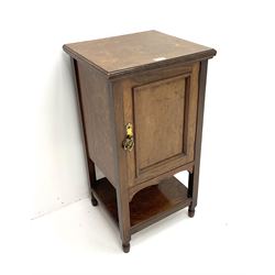 Edwardian oak bedside pot cupboard enclosed by panelled door, stile supports joined with with under tier 