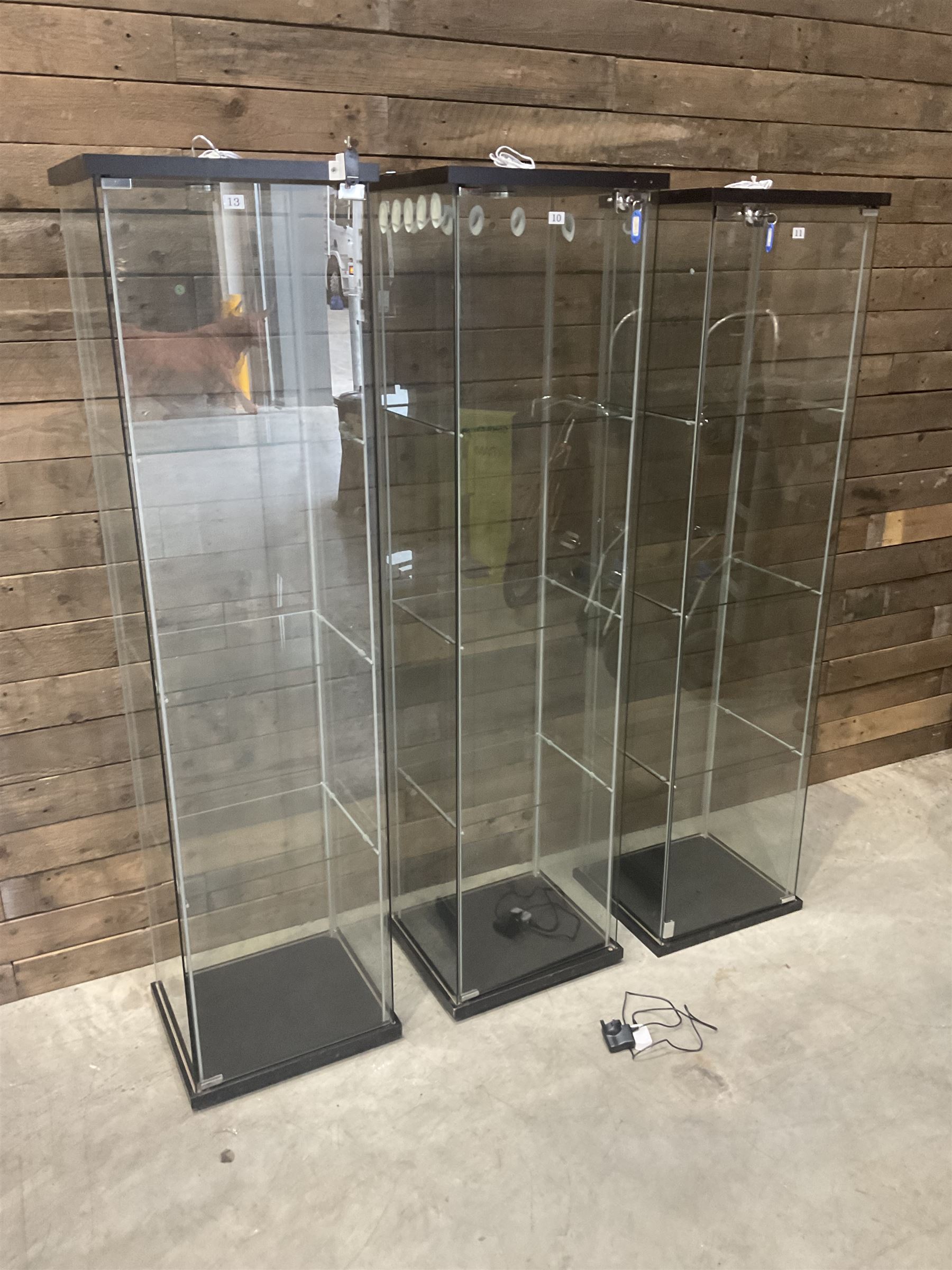 Three Ikea rosewood finish illuminated four glass shop display cabinets, with shelves and keys