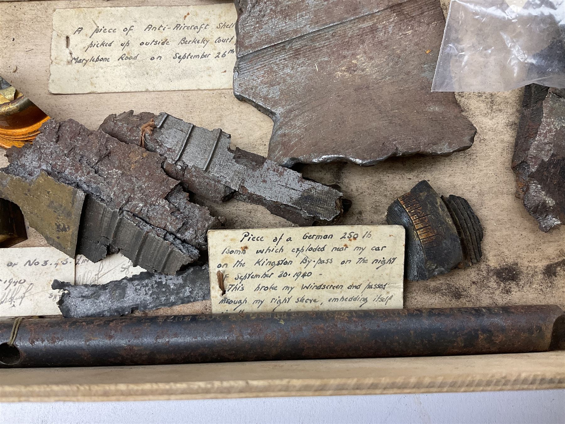 Small collection of WW2 shrapnel and German and British shell parts, most with manuscript details of where and when found including London, Leeds, Bristol, Linton-on-Ouse etc