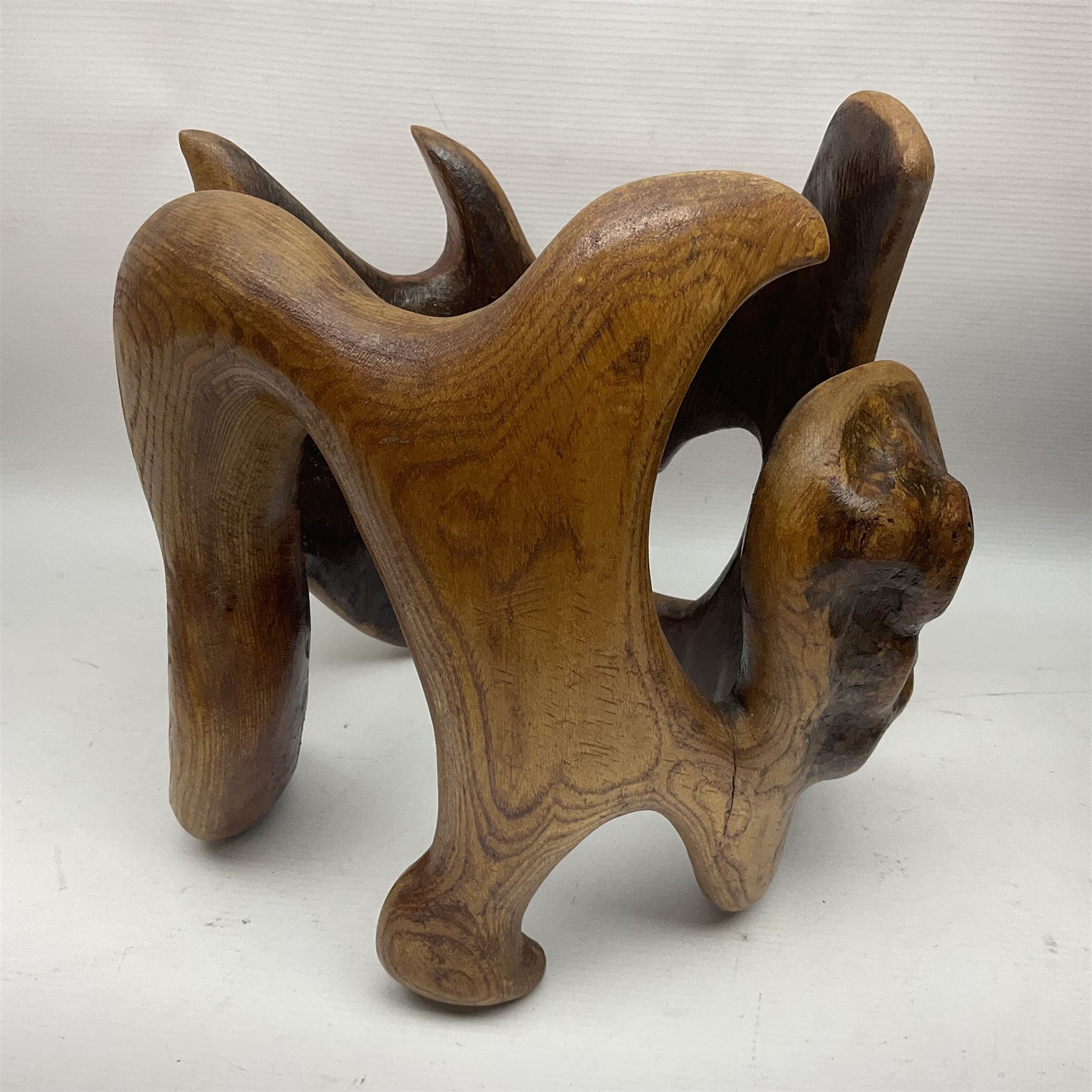 Helen Skelton (British 1933 – 2023): Two carved wooden abstract sculptures, one modelled as a entwined knot, largest H48cm. Born into an RAF family in 1933 in Kent and travelled the world extensively during her childhood. After settling in Bridlington, Helen immersed herself in painting, textiles, and wood sculpture, often inspired by nature's beauty. Her talent was showcased in a one-woman show at Sewerby Hall and recognised with the sculpture prize at Ferens Art Gallery in 2000. Sadly, Helen’s daughter passed away from cancer in 2005. This loss inspired Helen to donate her sculptures to Marie Curie upon her passing in 2023.
