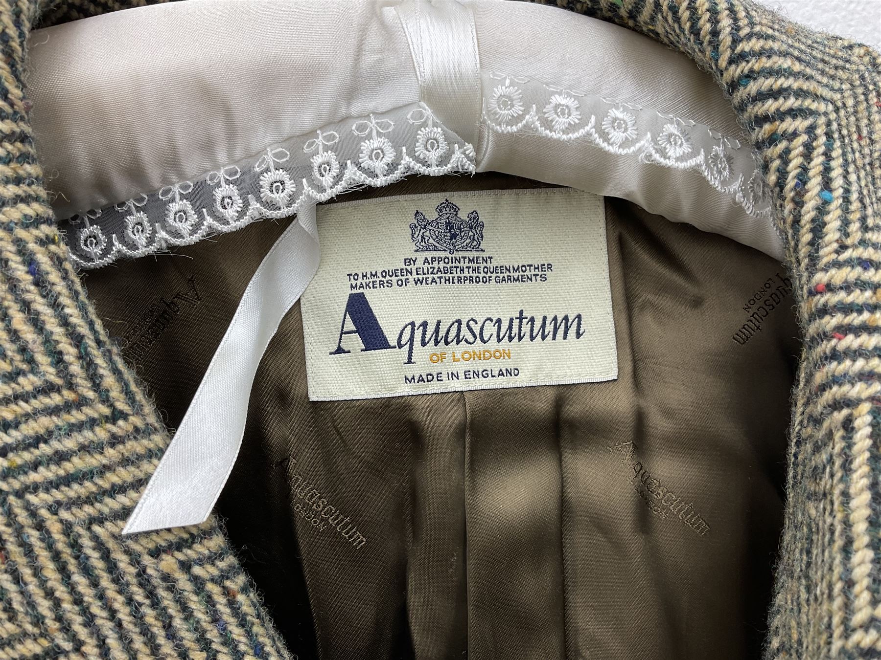 Men's Aquascutum lambs wool herringbone tweed coat with silk lining, 46 Reg, together with a further Men's Aquascutum grey wool duffle coat, with cheque lining and horn buttons, 46