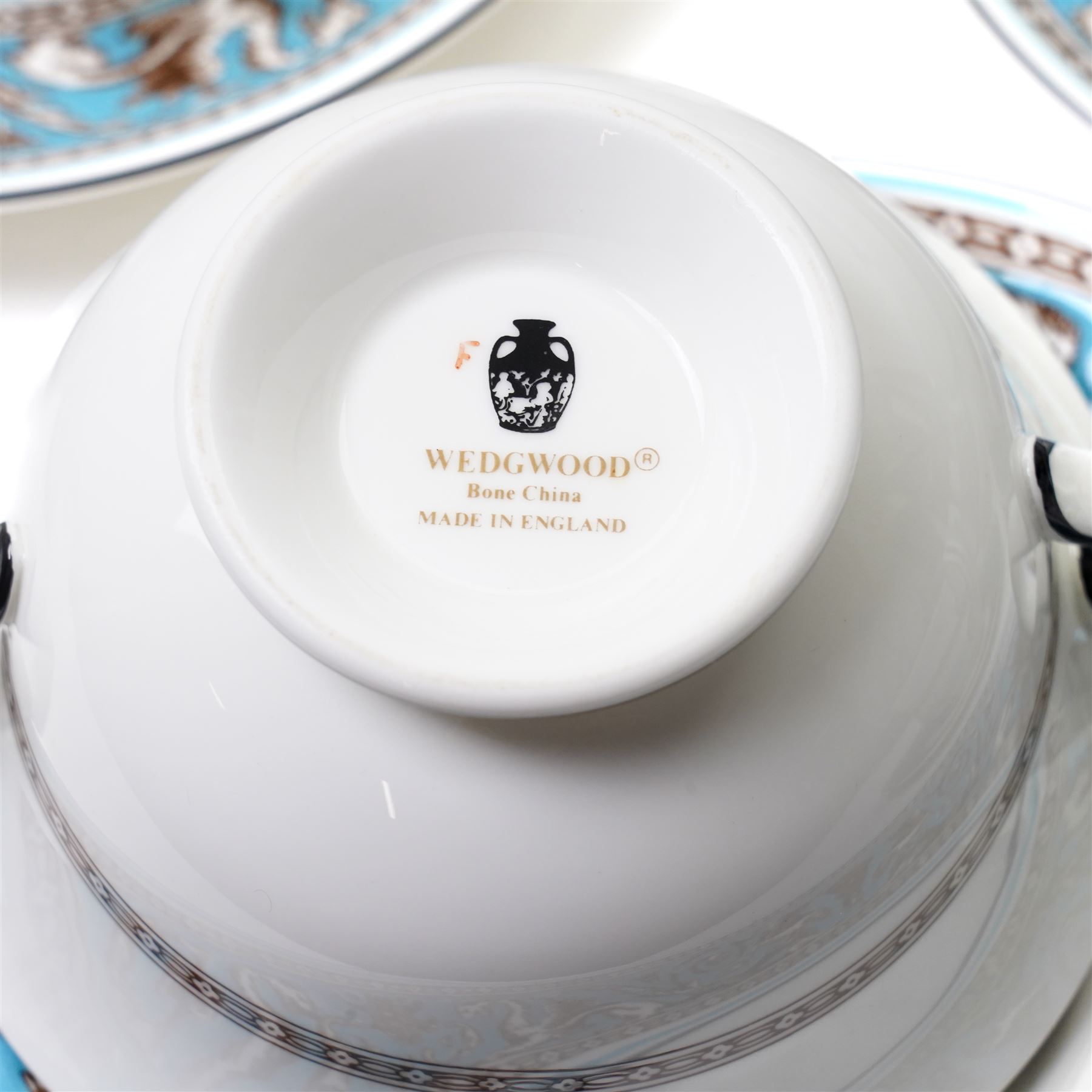 Wedgwood turquoise Florentine part service, comprising large covered tureen and stand, coffee pot, teapot, two covered sucriers, milk jug, two sauce boats and stands, seven soup plates, three bowls, jug, eighteen soup bowls and fifteen stands, two ashtrays, thirteen further saucers, twelve teacups and eleven saucers, and twenty-one further plates of varying sizes