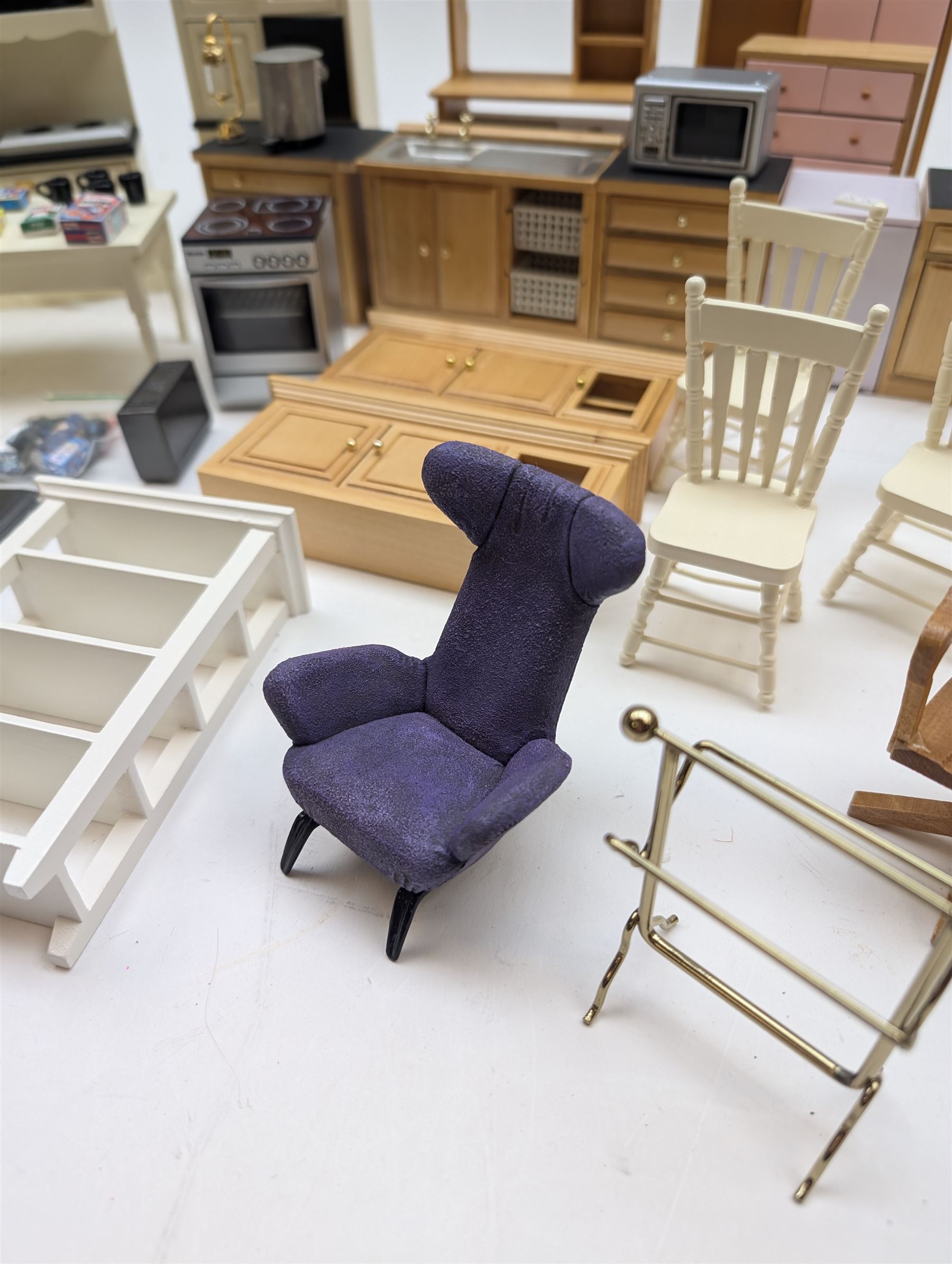 Modern 1:12 scale dolls house furniture, comprising pine kitchen set, with wall cabinets, floor cabinets and sink unit, white wooden bathroom suite, white wooden kitchen and dining room furniture and appliances, wooden bedroom furniture, Raine purple wingback chair, tv, desk, fish tank, etc