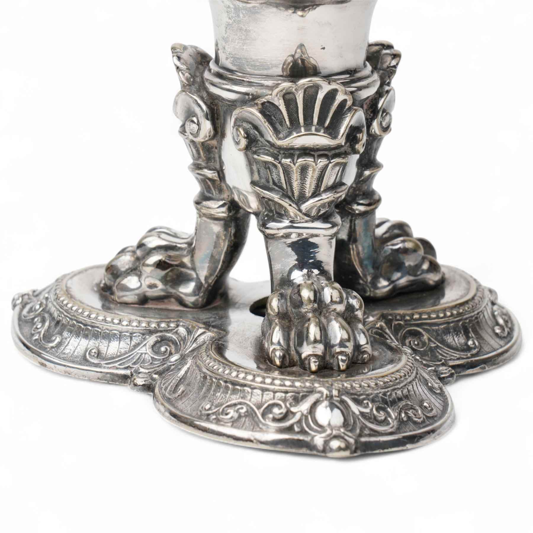 19th century silver plated vase of tapering form with lappet border and three caryatid handles surrounded with laurel wreath cartouches raised on triple paw feet on lobed base H28cm