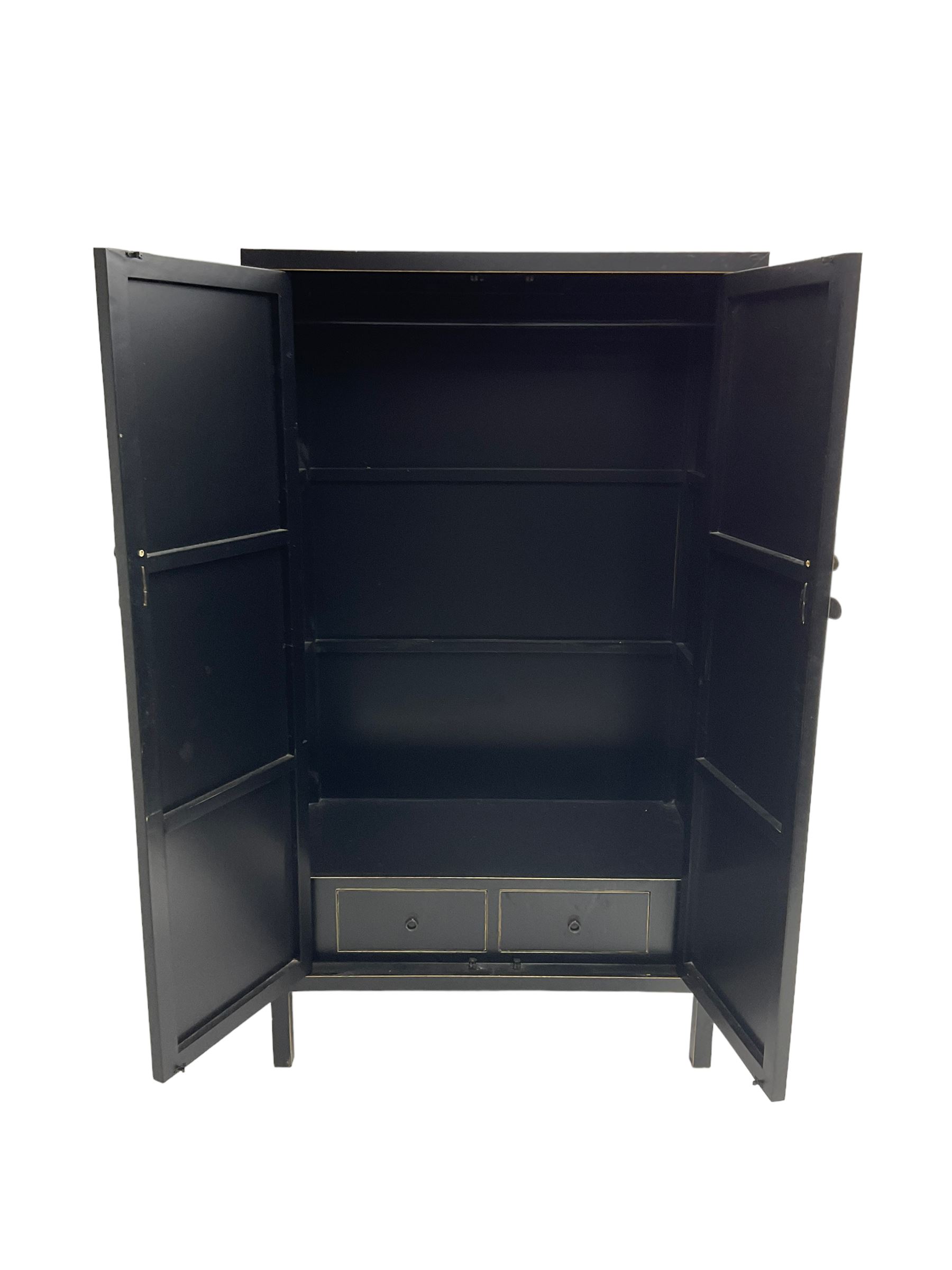 Chinese design black lacquered wardrobe, two cupboard doors enclosing hanging rail and two drawers