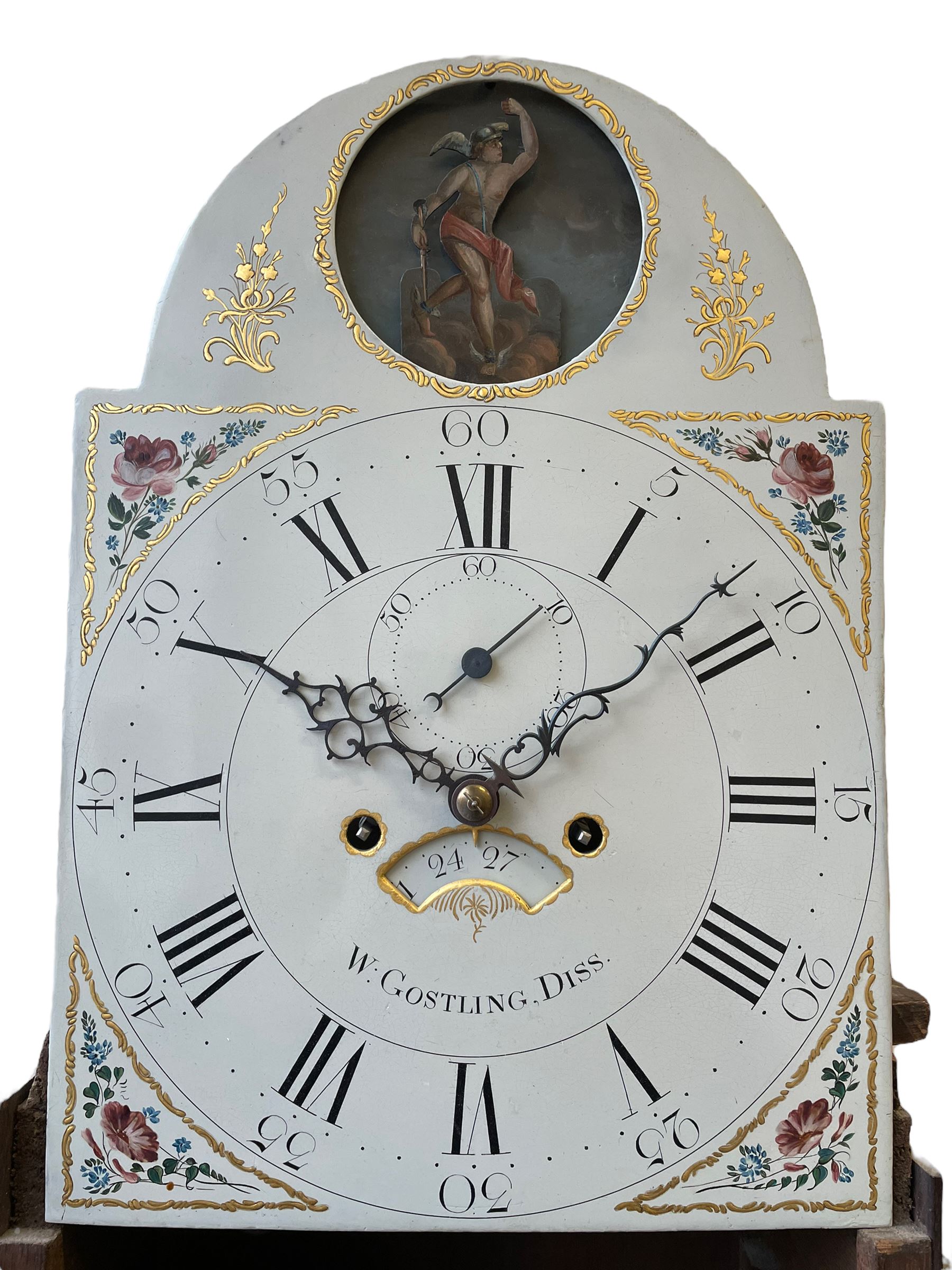 William Gostling of Diss  (Norfolk)-  Late 18th century 8-day oak longcase clock c1780-90, break arch top with scalloped cresting and three brass finials, glazed break arch hood door flanked by turned pilasters with brass capitals, trunk with a long trunk door and rounded top on a square plinth with an applied and shaped skirting, early painted Wilson of Birmingham dial with Roman numerals and five minute Arabic's, matching steel hands and second pointer, arched square ended calendar aperture with date disc behind, floral spandrels within gesso borders and a painted rocking automaton representing Mercury to the break arch, dial pinned via a false plate to a weight driven rack striking movement with a recoil anchor escapement, striking the hours on a cast bell. With pendulum weights and key. 
William Gostling (II) is recorded as working in Diss from 1774 to 1797, succeeded by widow Anne and son George . The dial of this clock is illustrated and discussed in detail in M.F. Tennants book 