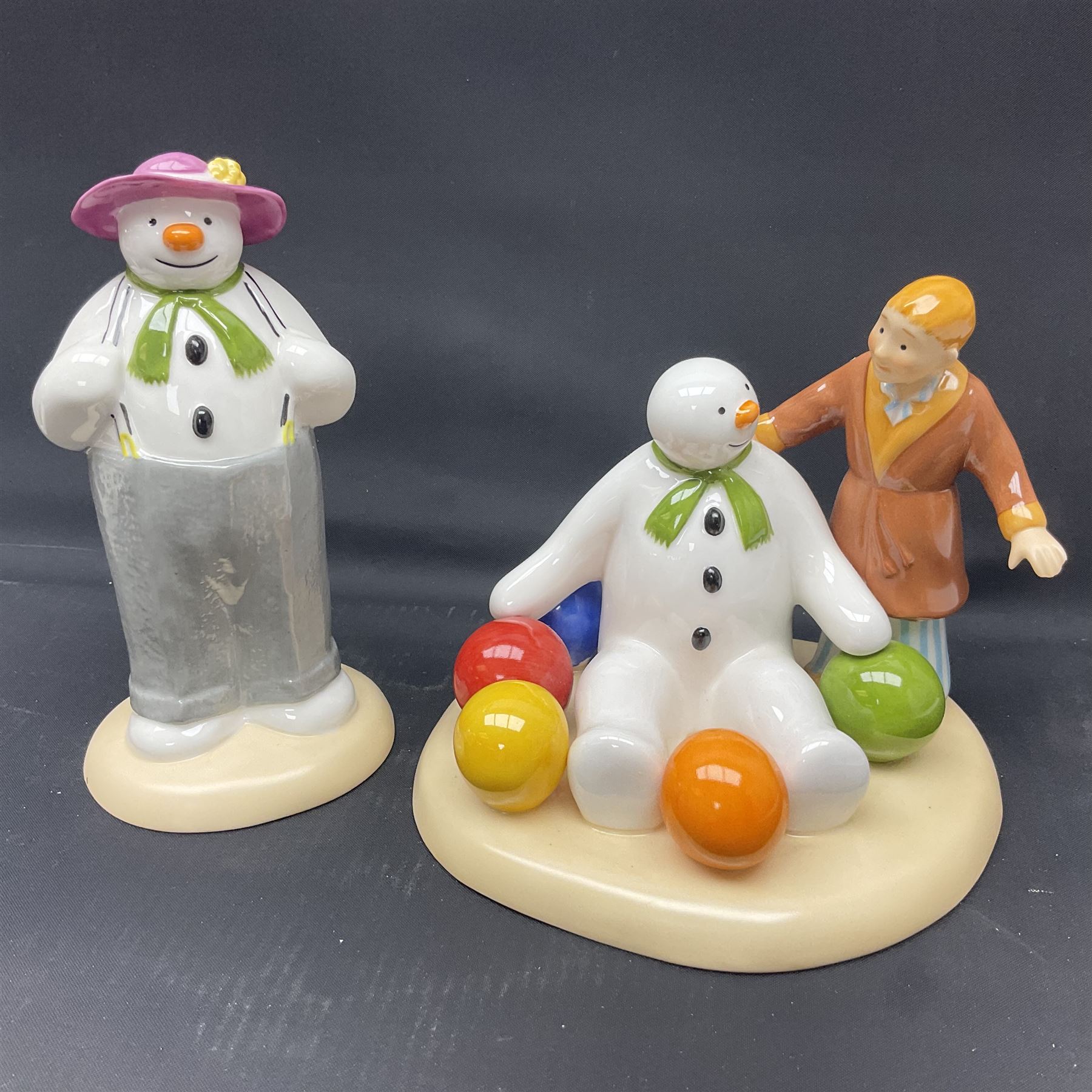 Four Coalport Characters The Snowman figures, comprising Dancing the Night Away with certificate, Penguin Pals, with certificate, Dressing Up and Soft Landing, all with original boxes 