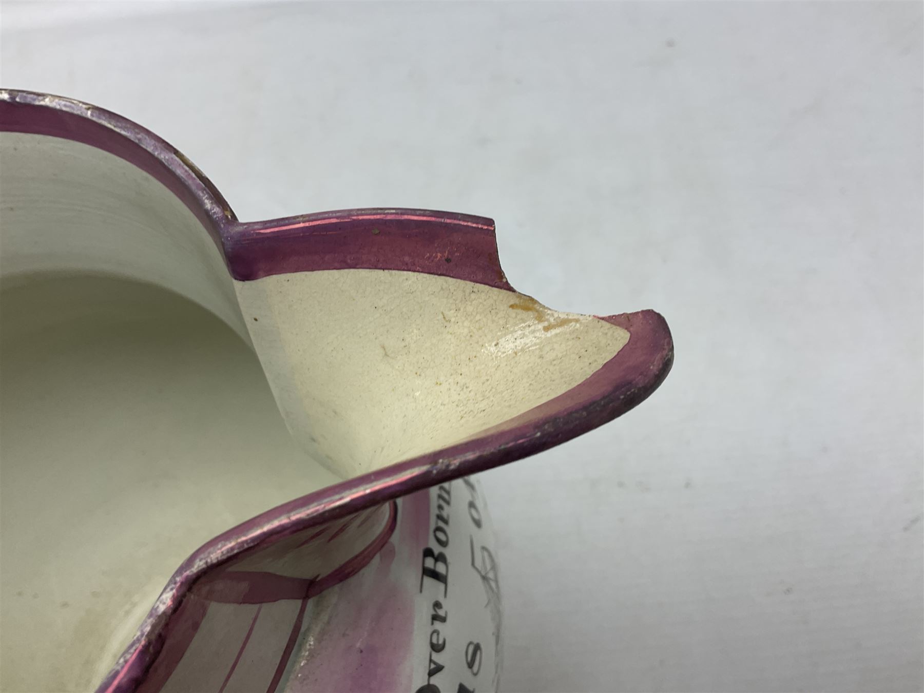 Early 20th century Sunderland lustre jug, decorated with transfer Masonic scene and poem 'The World is in Pain/Our Secrets to Gain/But Still Let Them Wonder and Gaze/The Never Can Divine/The World Nor The Sign/Of a Free and Accepted Mason', the reverse decorated with Sunderland River Wear cast iron bridge scene below text (a/f), together with a copper lustre jug, and pink lustre bowl, jug H20cm