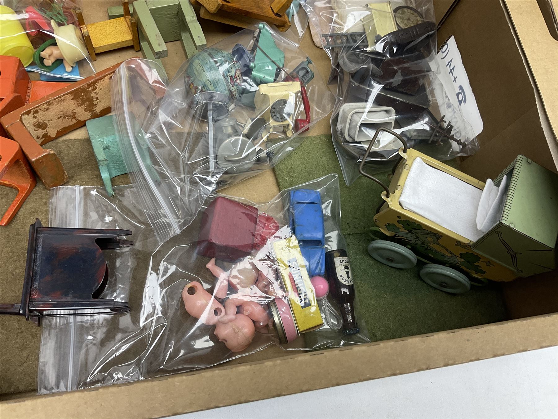 Quantity of various scale 1930s doll's house furniture including wooden grand piano, tables and chairs etc; plastic accessories including Fairy Lite sewing machine, trays, table wares, buckets, high chair etc; metal items including tin-plate doll's pram, terrestrial globe, die-cast typewriter and telephone, companion set and coal scuttle etc