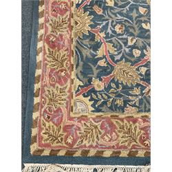 Blue ground rug overall foliate design with stylised leaf motifs within multiple border