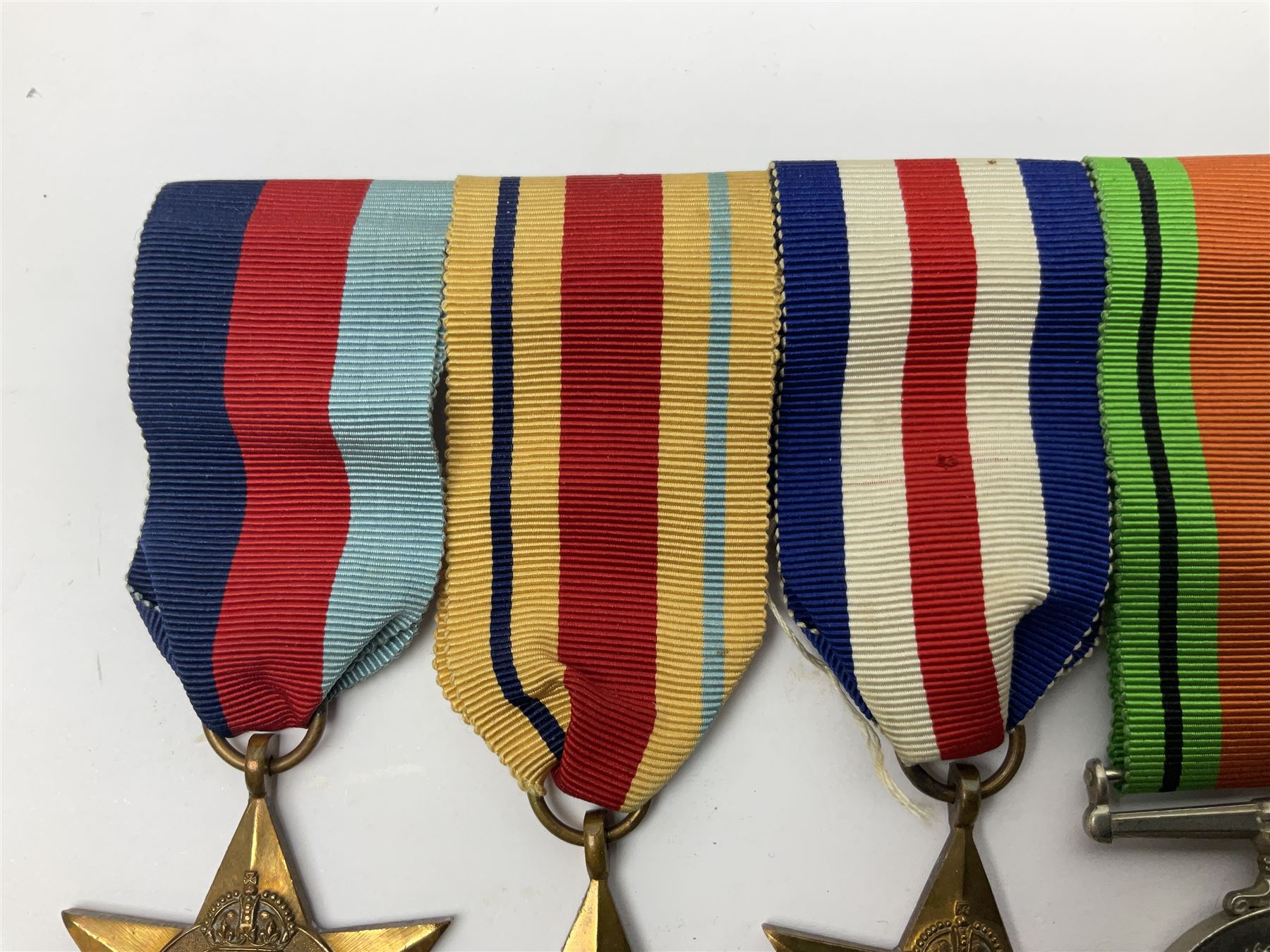 WWII group of five medals comprising 1939-45 War Medal, Defence Medal, 1939-45 Star, Africa Star and France and Germany Star on wearing bar; WWI British War Medal awarded to 142019 Pte. A. Thompson A.S.C.; and boxed King's Badge 'For Loyal Service'