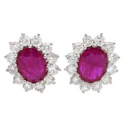 Pair of 18ct white gold oval ruby and round brilliant cut diamond stud earrings, stamped 18K, total ruby weight approx 3.15 carat, total diamond weight approx 2.15 carat