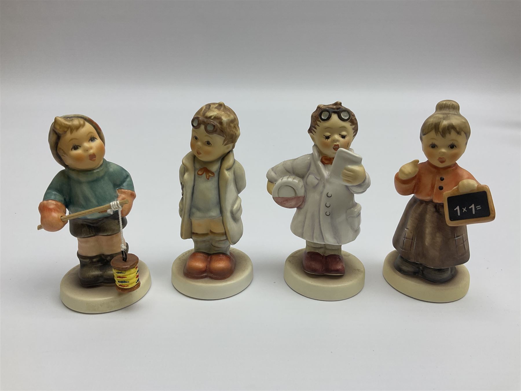 Thirty Hummel figures by Goebel, to include Saluting the Peacekeepers of Operation Joint Endeavor, on wooden plinth, Call to Glory, Celebrate with Song and Soldier Boy