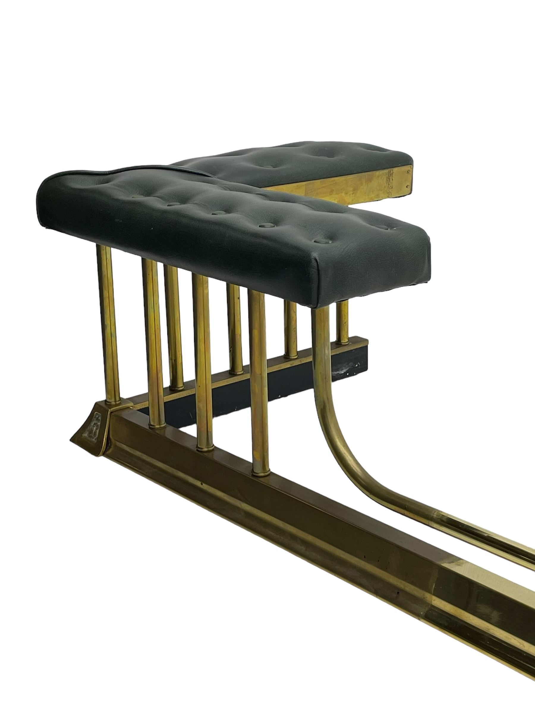 Victorian design brass telescopic extending club fire fender, the corner seats upholstered in buttoned green fabric over plain balustrade, on moulded base with floral cast corner brackets 