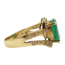 Gold oval emerald ring with diamond swirl surround and shank, stamped 14K