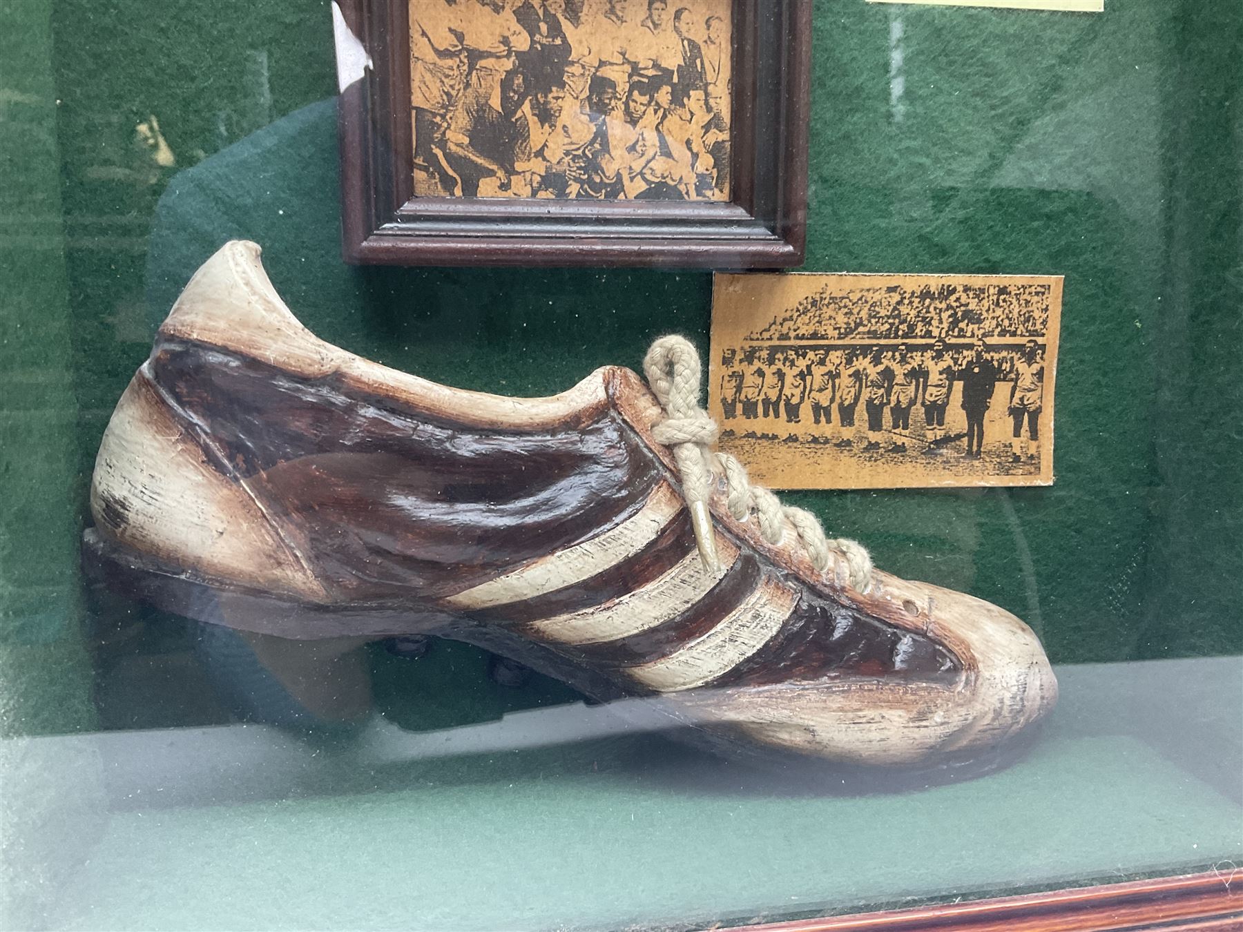 Four framed sporting memorabilia displays, the largest example containing 1930s cricket memorabilia, together with two fishing displays and a football display, each within wooden glazed frames, largest H105cm