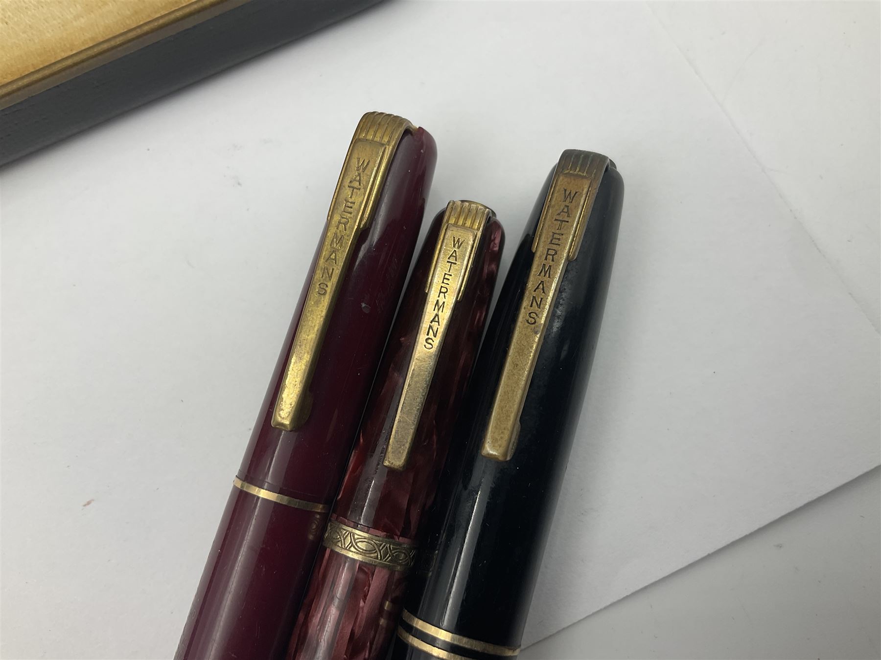 Group of Waterman pens and propelling pencils, to include a fountain pen, the black barrel with rolled gold cap and nib stamped 14ct, together with a matching propelling pencil, in box, together with a further fountain pen with gold nib stamped 14ct, stainless steel fountain pen and rollerball set in box, propelling pencil with maroon barrel etc, largest L13cm (7)