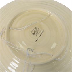 Clarice Cliff Bizarre for Newport Pottery dish, decorated in the Canterbury Bells pattern, with stylised flowers in blue, yellow and orange amongst foliage upon a brown and yellow ground, with printed mark beneath, D33cm