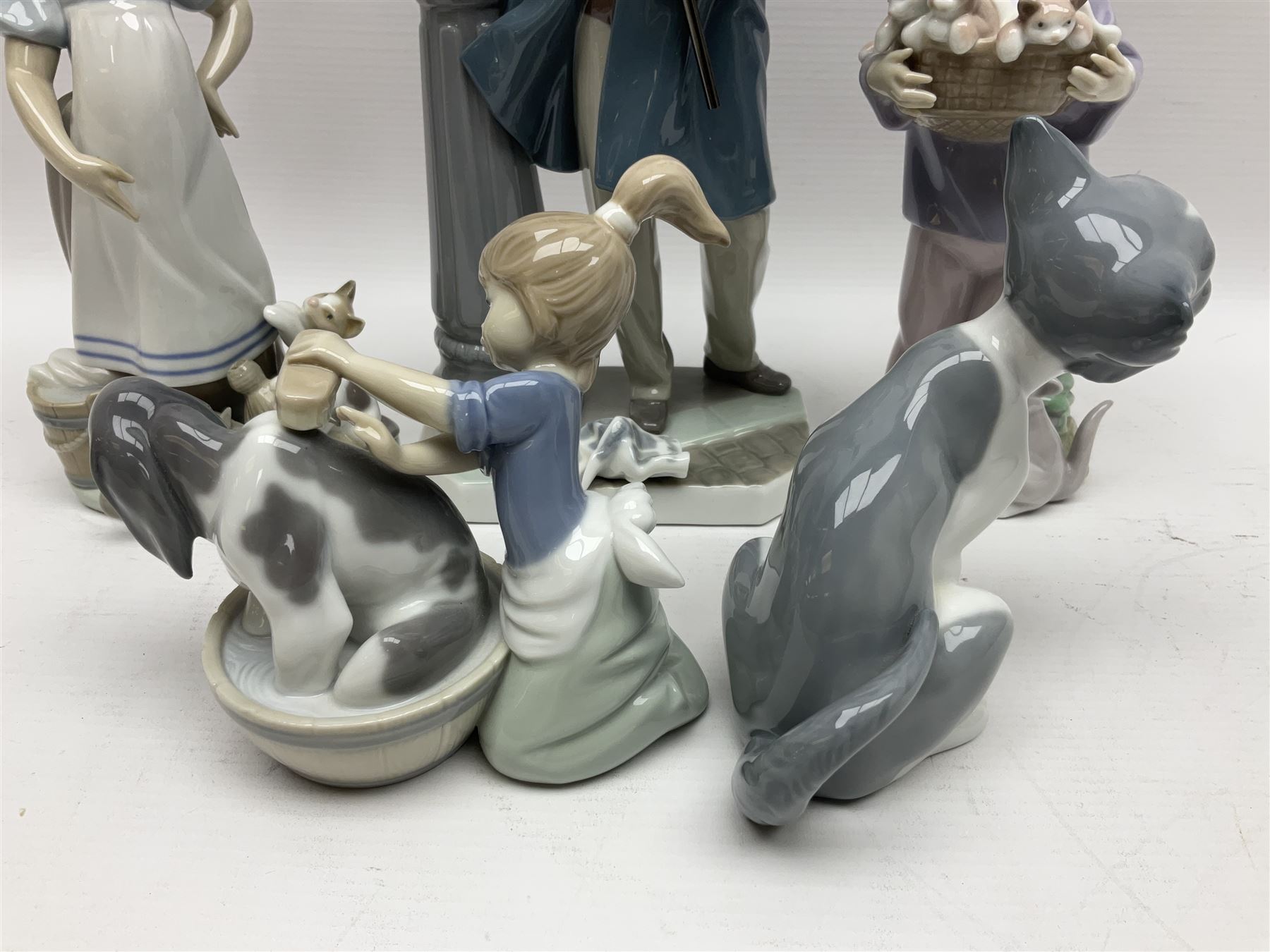Five Lladro figures, including The Lamp Lighter no 5205,  Girl and Kittens no 6102, Cat no 5113 etc