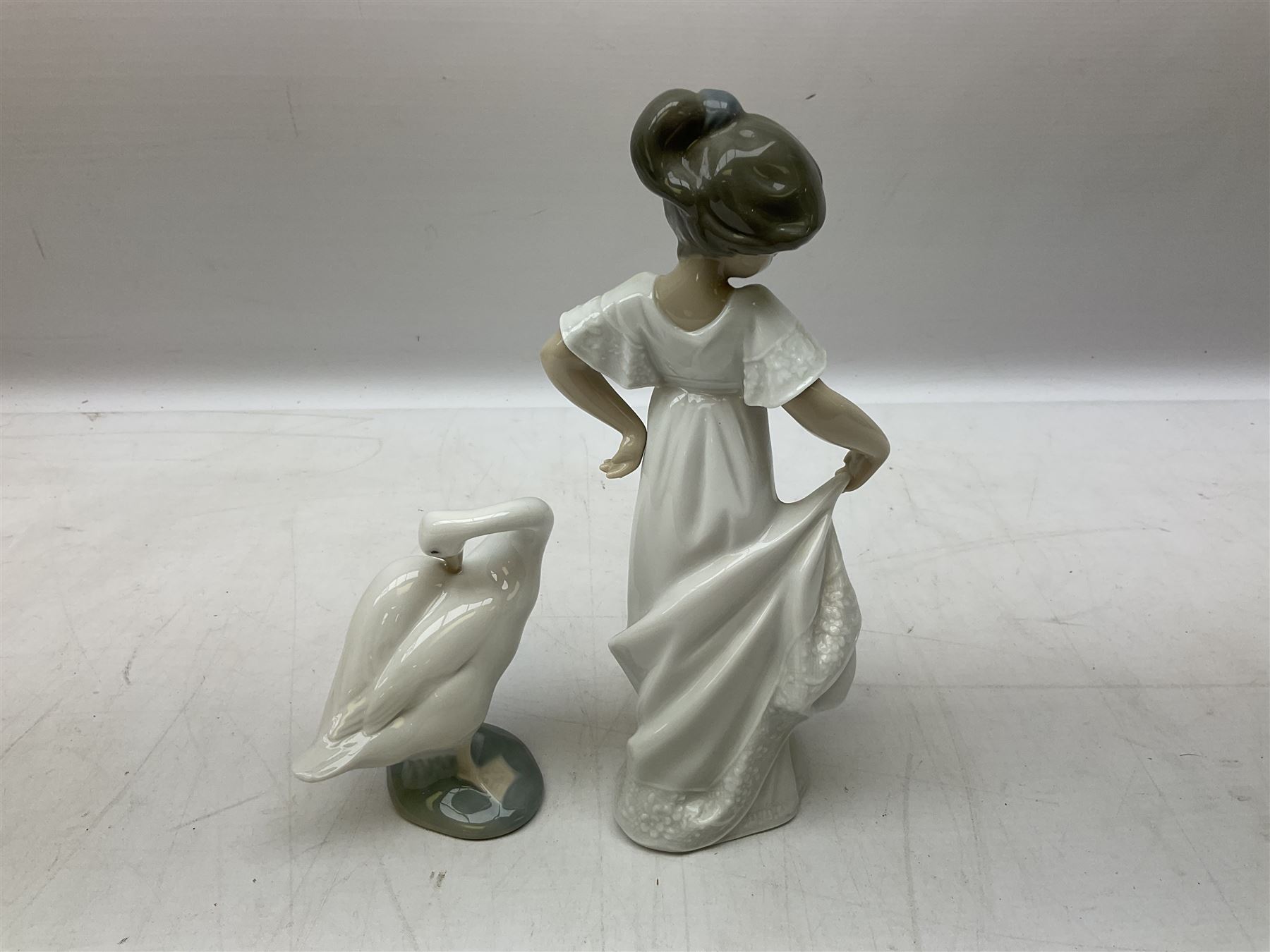 Quantity of figures to include Lladro example modelled as swan together with three Nao figures to include two April Showers no 1126, two with boxes 