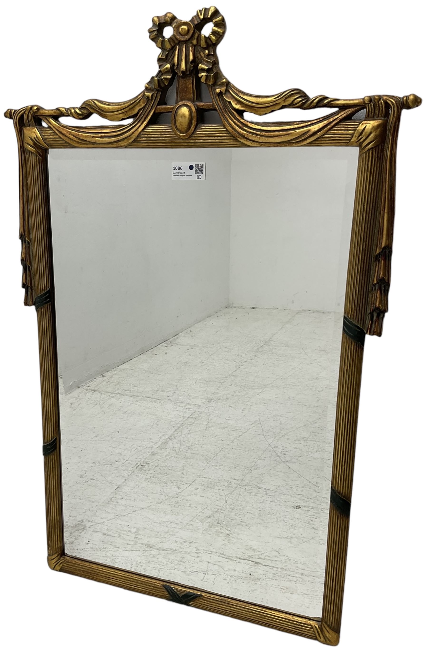 Regency design gilt framed wall mirror, ribbon pediment over hanging linen swags, bevelled mirror plate enclosed by reed moulded frame 