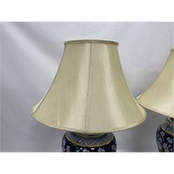 Pair of blue and white table lamps, each of baluster form, decorated with prunus blossom, within stylised borders, raised upon circular gilt base, excluding fittings H48cm