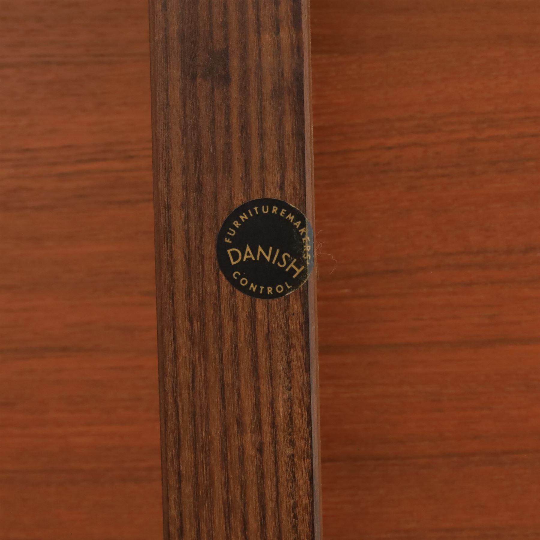 Frem Røjle - Danish teak 'Roundette' extendable dining table, circular top with softly chamfered edge and internal stowable leaf extends to 156cm, raised on four tapered cylindrical legs, accompanied by four matching dining chairs with shaped teak frames and black vinyl upholstered seats, the chairs designed to nest beneath the table when not in use