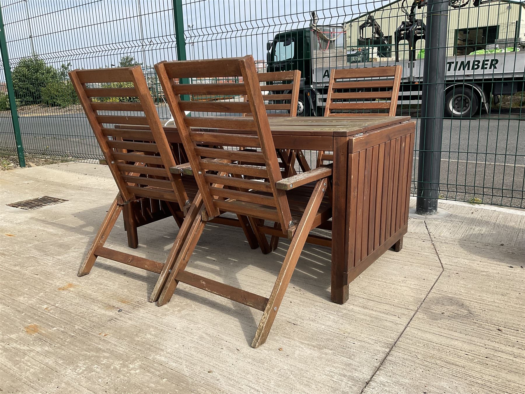 Rectangular teak drop leaf garden table, and four slatted armchairs