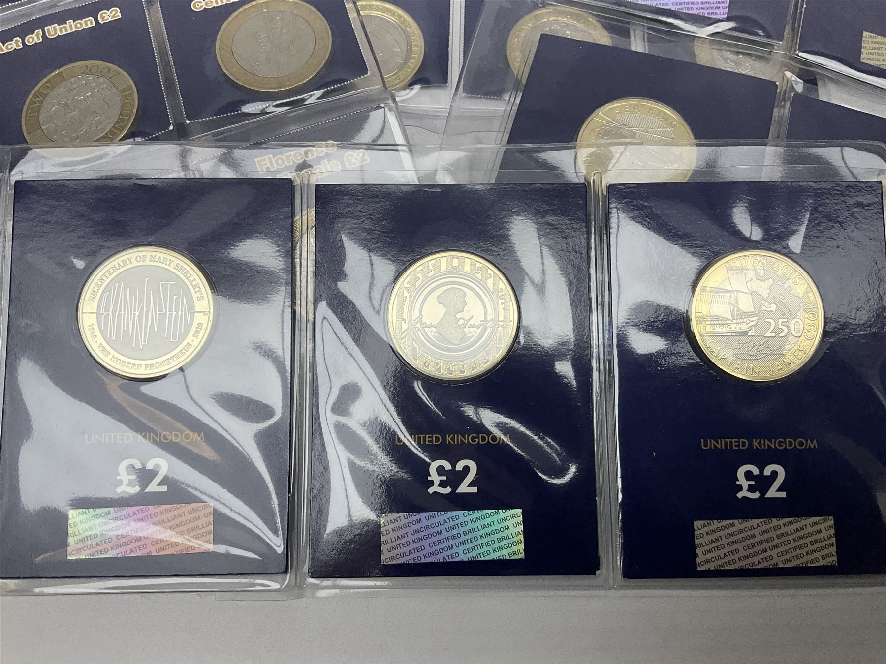 Mostly United Kingdom Queen Elizabeth II commemorative two pound  coins, including 2017 'Jane Austen', 2018 'Sea King', 2018 'Vulcan' etc face value of UK coins approximately 98 GBP