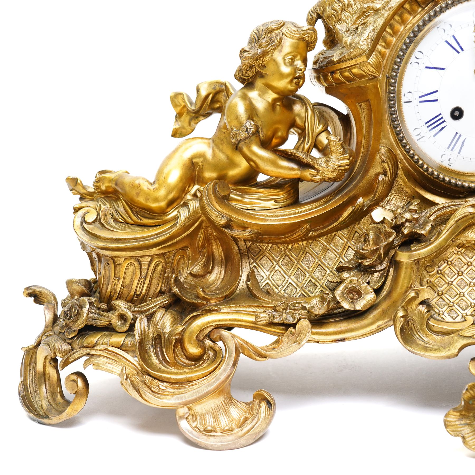 French-large late 19th-century 8-day Louis XV style gilt bronze mantel clock, with a cast rococo style case, elaborate C-scrolls, shells, and floral sprays, surmounted by a seated putto and goat symbolising pastoral love, flanked by two further seated putti on a scrolled foliate base, 5