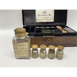 19th century apothecary leather carrying case, with key, the hinged lid opening to reveal seventeen glass medicine bottles with stoppers, most with chemist labels, gram scales, and domestic medicines booklet, H9cm, L27cm