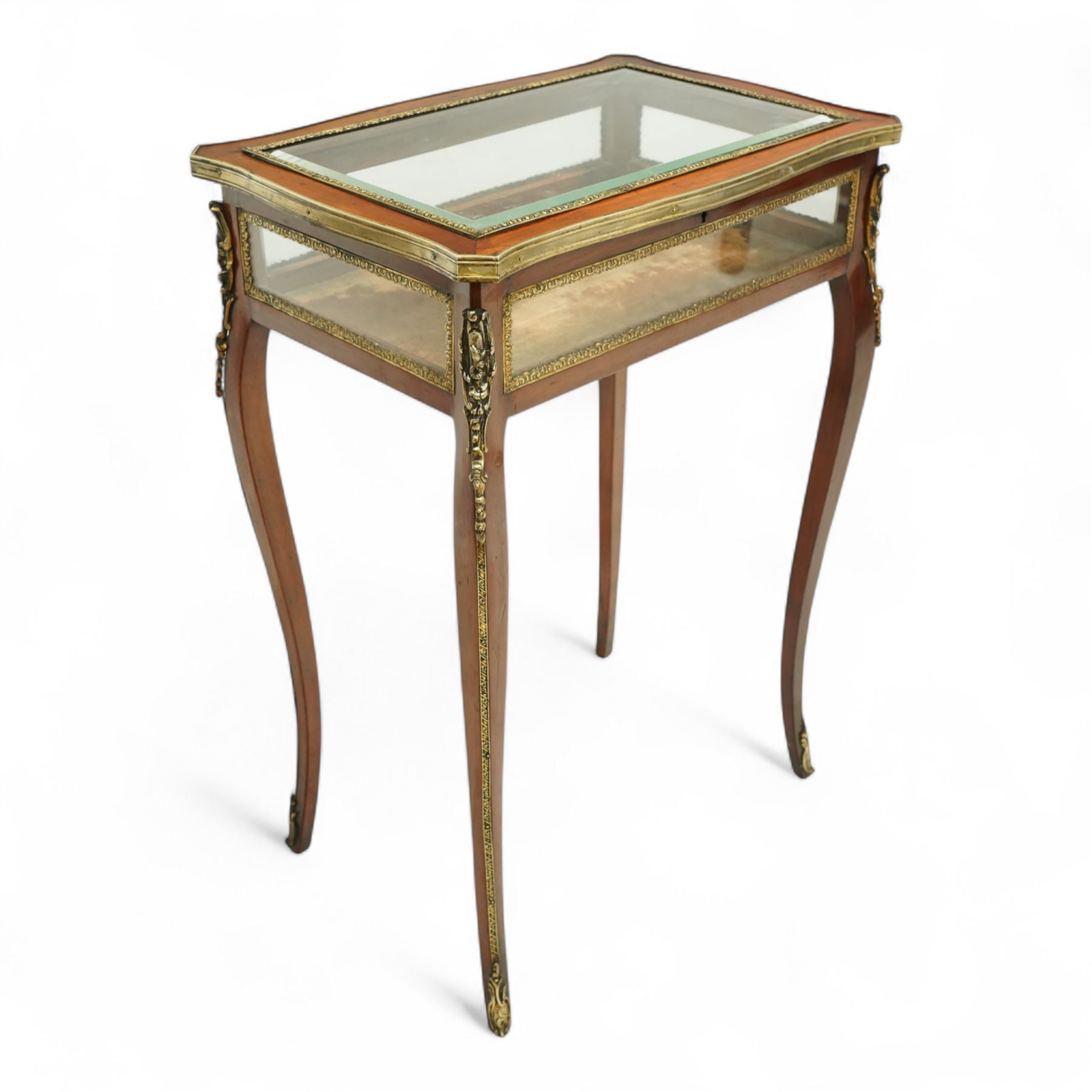 19th century, Louis XV style, bronze mounted bijouterie table, the hinged rectangular bevelled glass top with gilt bronze foliate beading, side glass panels  and plush-lined velvet interior, raised on cabriole legs, with gilt bronze masks and sabots
