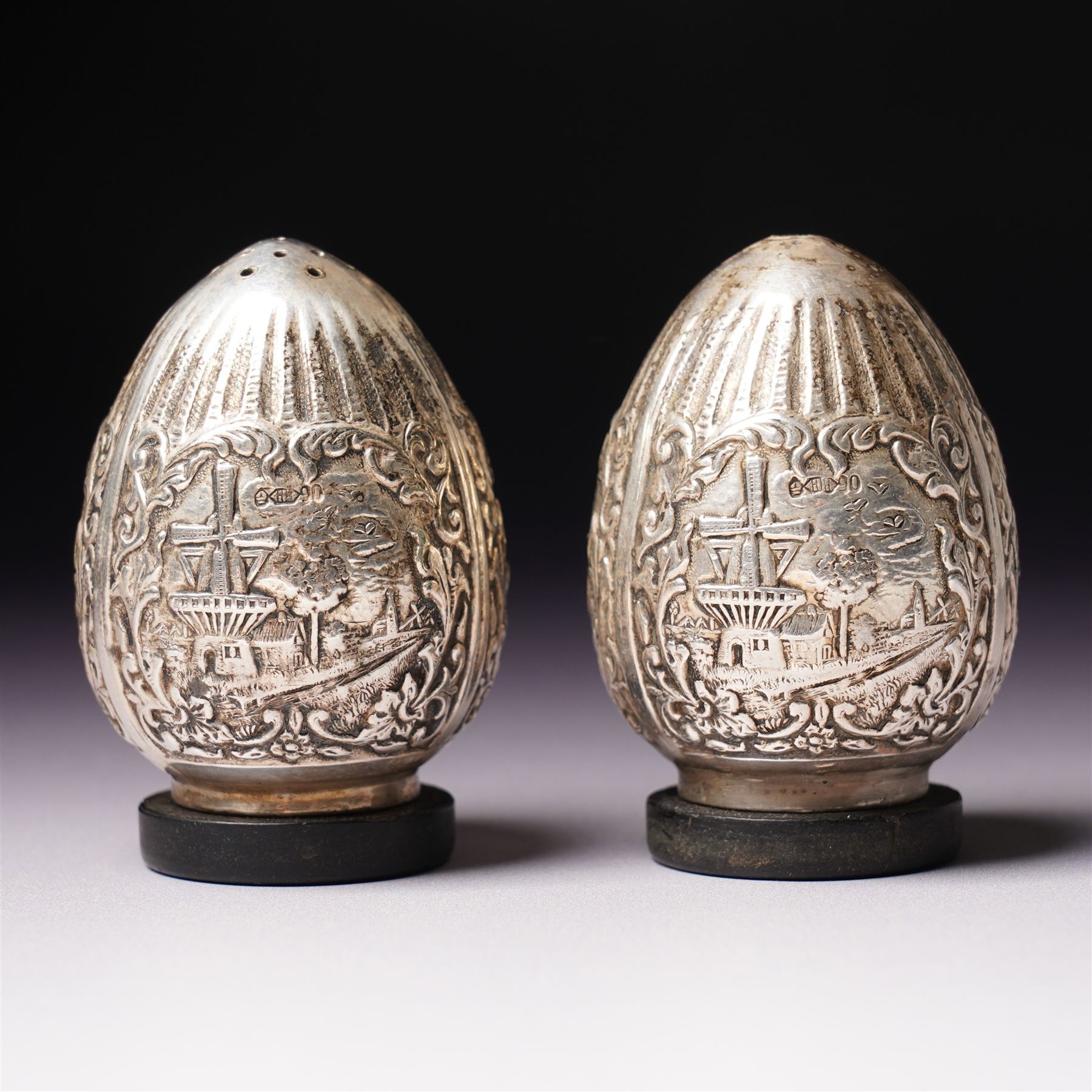 Dutch 90 standard silver salt and pepper pots of ovoid design decorated with windmills etc H6cm