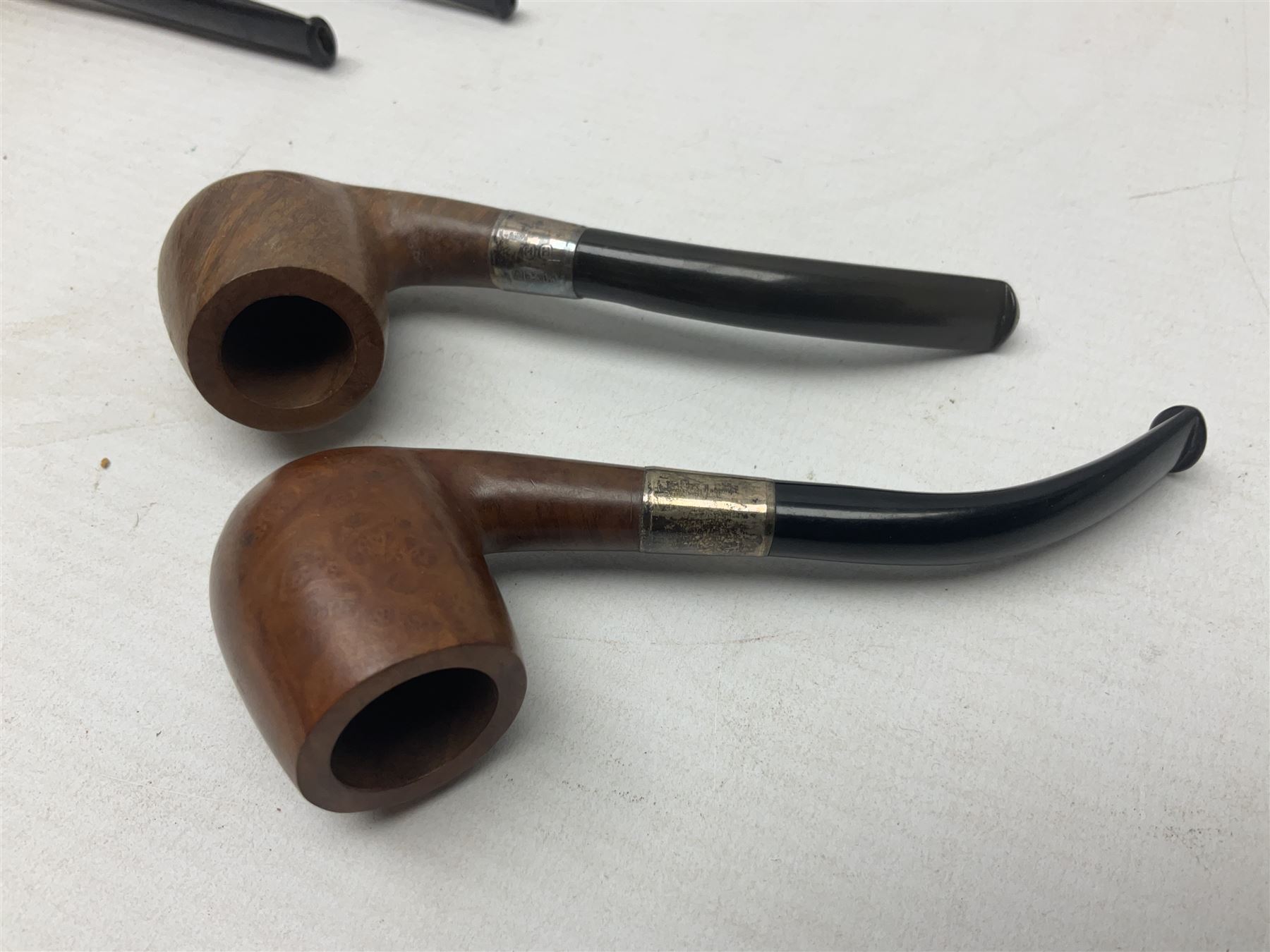 Collection of eight silver mounted pipes, comprising a briar wood Imperial ITC example with silver collar hallmarked A.W Birmingham 1903, horn handled example with silver collar hallmarked LB, probably Louis Blumfeld, Birmingham 1900, three examples marked B.W, one marked Globe A.O.C, Blumfeld's Best Briar pipe marked BBB and Riseagle example, together with two further pipes (10)