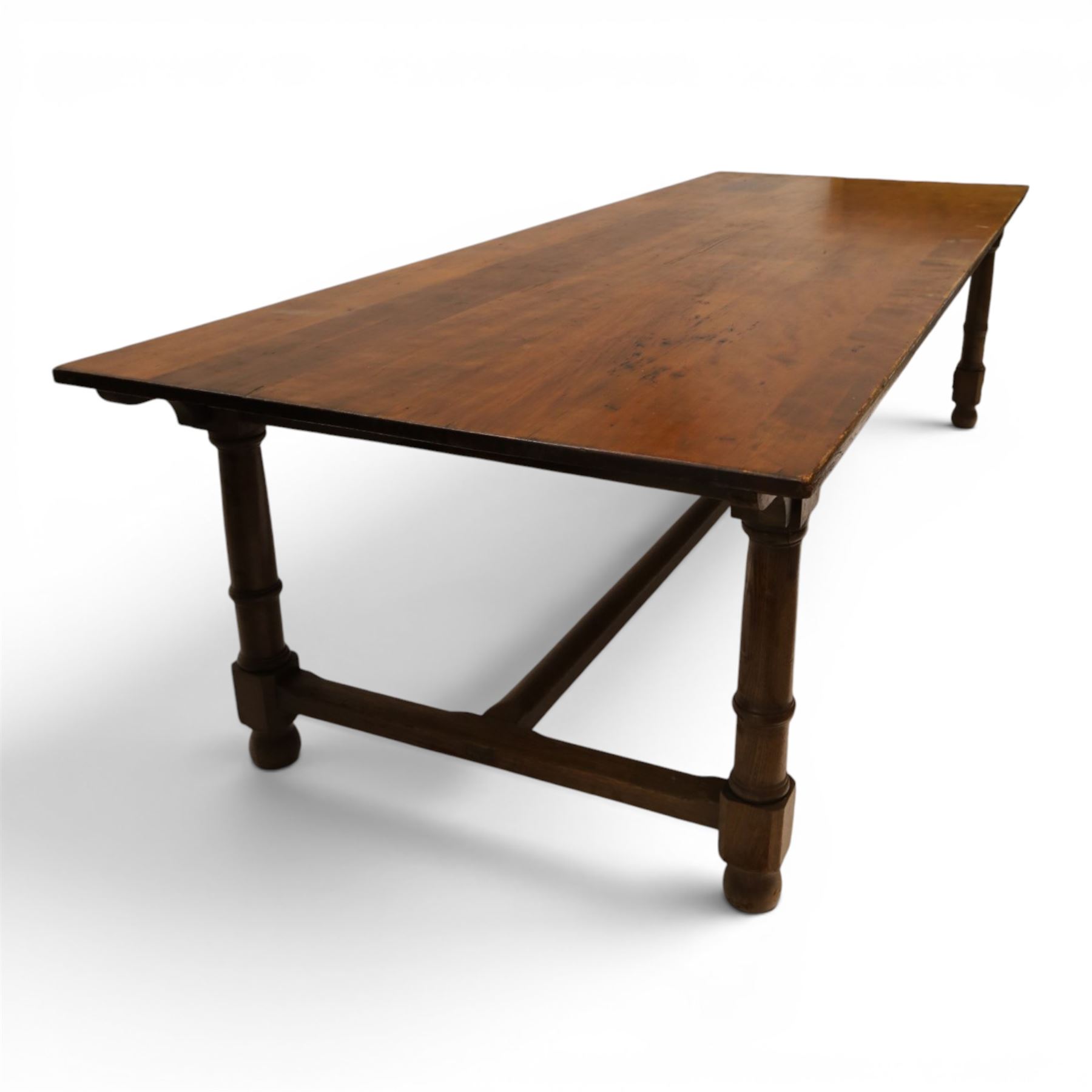 Large oak and pine farmhouse table, with pine plank top raised on and oak base with turned supports united by a long stretcher 