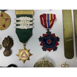 Collection of approximately sixty worldwide medals, metal badges, belt buckles, cloth badges, trench art, brass button stick etc
