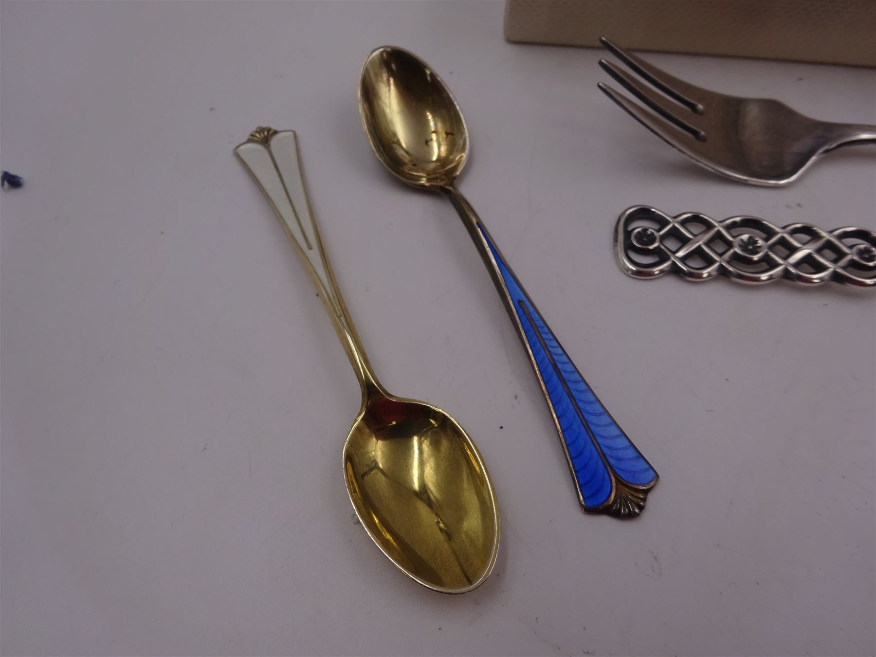 Mid 20th century Norwegian silver Christening spoon and fork set with openwork lattice detail to finials, both stamped David Anderson 830S verso, in original box, together with three silver-gilt enamel coffee spoons, the larger example with green guilloche enamel to bowl and handle, all by David Anderson, stamped D-A 925S Norway Sterling verso