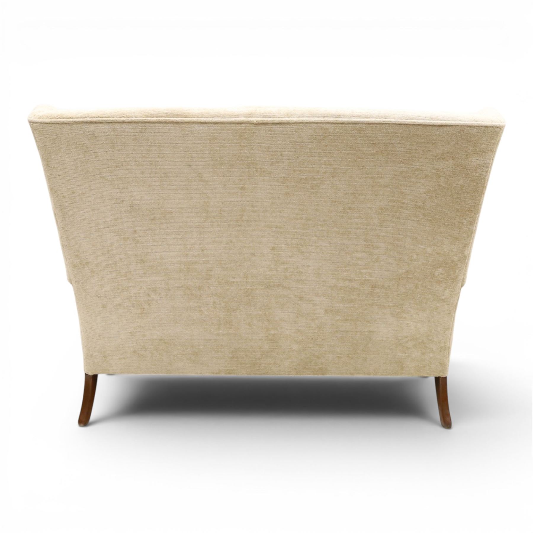 Parker Knoll - 'Hartley' lounge suite, comprising three wingback armchairs and two-seat settee, upholstered in cream fabric, shaped wing backs with scroll-over arms and loose seat cushions, on cabriole supports with pad feet wingbacks and settee

Armchairs: H 96cm, D 83cm, W 75cm