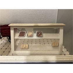 Three scratch-built wooden shop dioramas - single room Pet Shop with hinged front, fully furnished and well stocked with animals, birds and numerous accessories; and matching Garden Shop, fully furnished and well stocked with fruit, vegetables and garden accessories including lawn mower, wheelbarrows etc; each W34cm H27cm D26cm; and double fronted single room Butchers Shop with butcher at his block, partially stocked counter and two delivery cycles W57cm (3)
