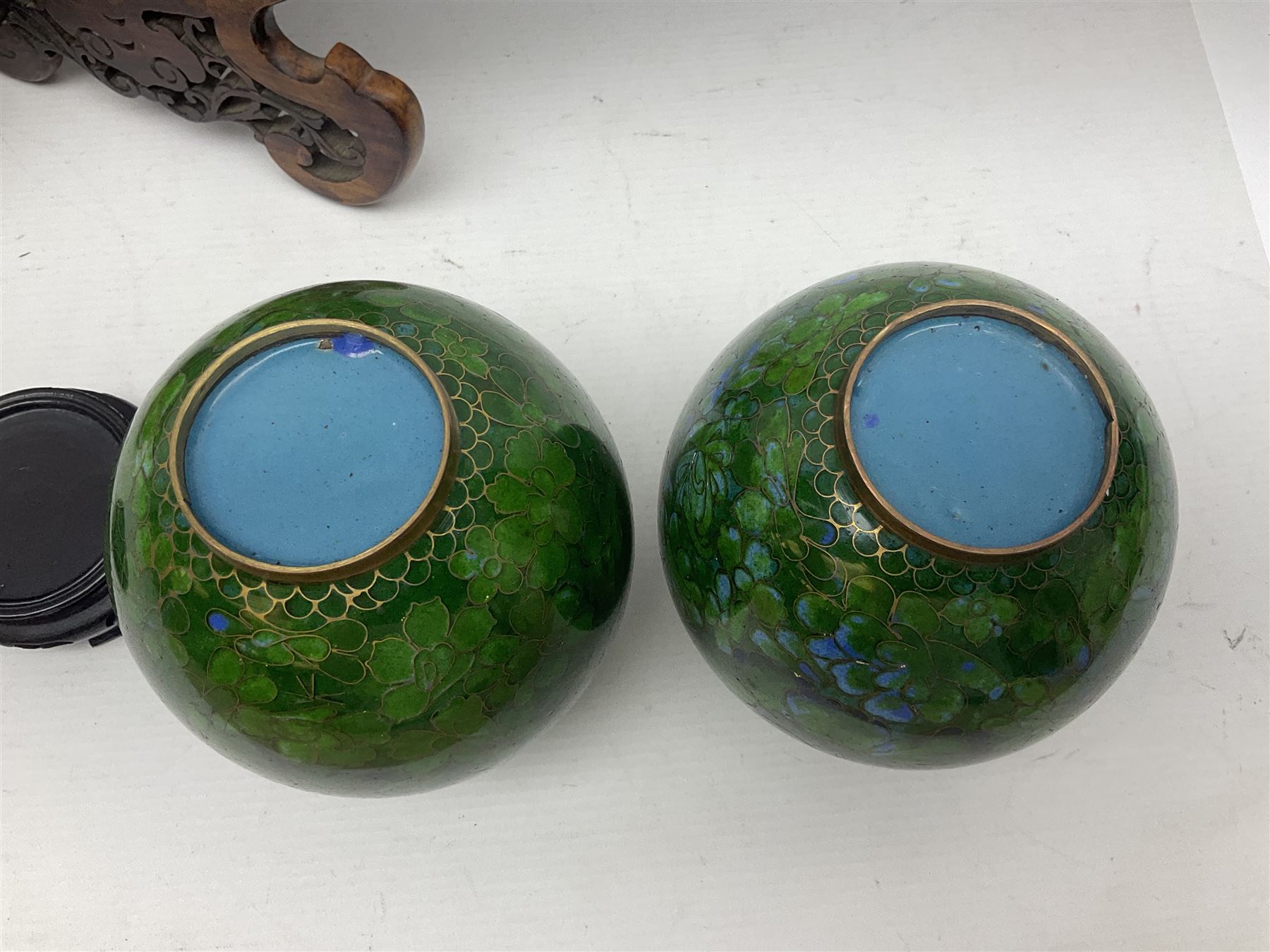 Pair of modern cloisonne ginger jars having floral decoration with a green ground, with hardwood stands, together with a similar plate and a bowl decorated with birds and flowers  