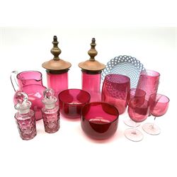 A group of Victorian and later cranberry glass, to include jug, pair of fingerbowls, three drinking glasses, pair of bottles with stoppers, pair of glass light shades with part bases, etc., together with a Sowerby blue milk glass basket weave dish, with mark beneath. 