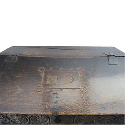 18th century carved oak Bible box on stand, the sloping lid with incised initials ‘MD’ and iron strap hinges, the front carved with stylised leaf and scroll panels enclosing central iron lockplate, on stand with gadrooned frieze, turned legs and plain stretchers