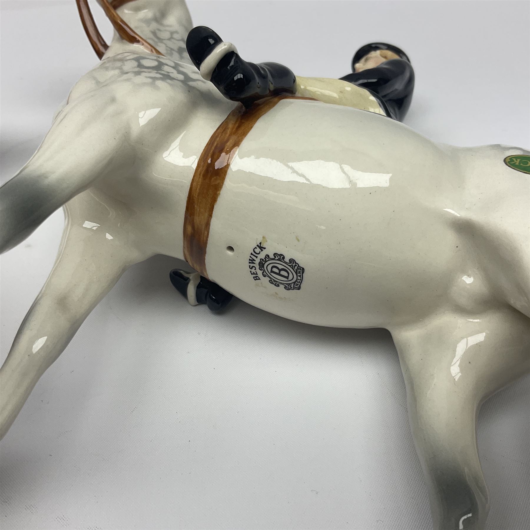 Beswick hunting group, comprising huntswoman on dappled grey horse no 1730, huntsman on bay horse no 1501, two fox figures no 1440 and 1748, and four fox hounds, all with printed marks beneath (8)