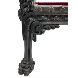 Grand mid-to-late 19th century heavily carved beech framed throne chair, the crown pediment carved with flower heads and cross finial, scroll and acanthus carved upright supports with twin perching griffin back enclosing etched leather work heraldic shield with castle and lion motifs over splayed feathers, flower head carved down sweeping arms with grotesque carved terminals, the seat rails carved with further flower heads on moulded supports with oversized ball and claw carved feet

Provenance: A very similar chair was used in the filming of Stanley Kubrick's 'Eyes Wide Shut' (1999)
