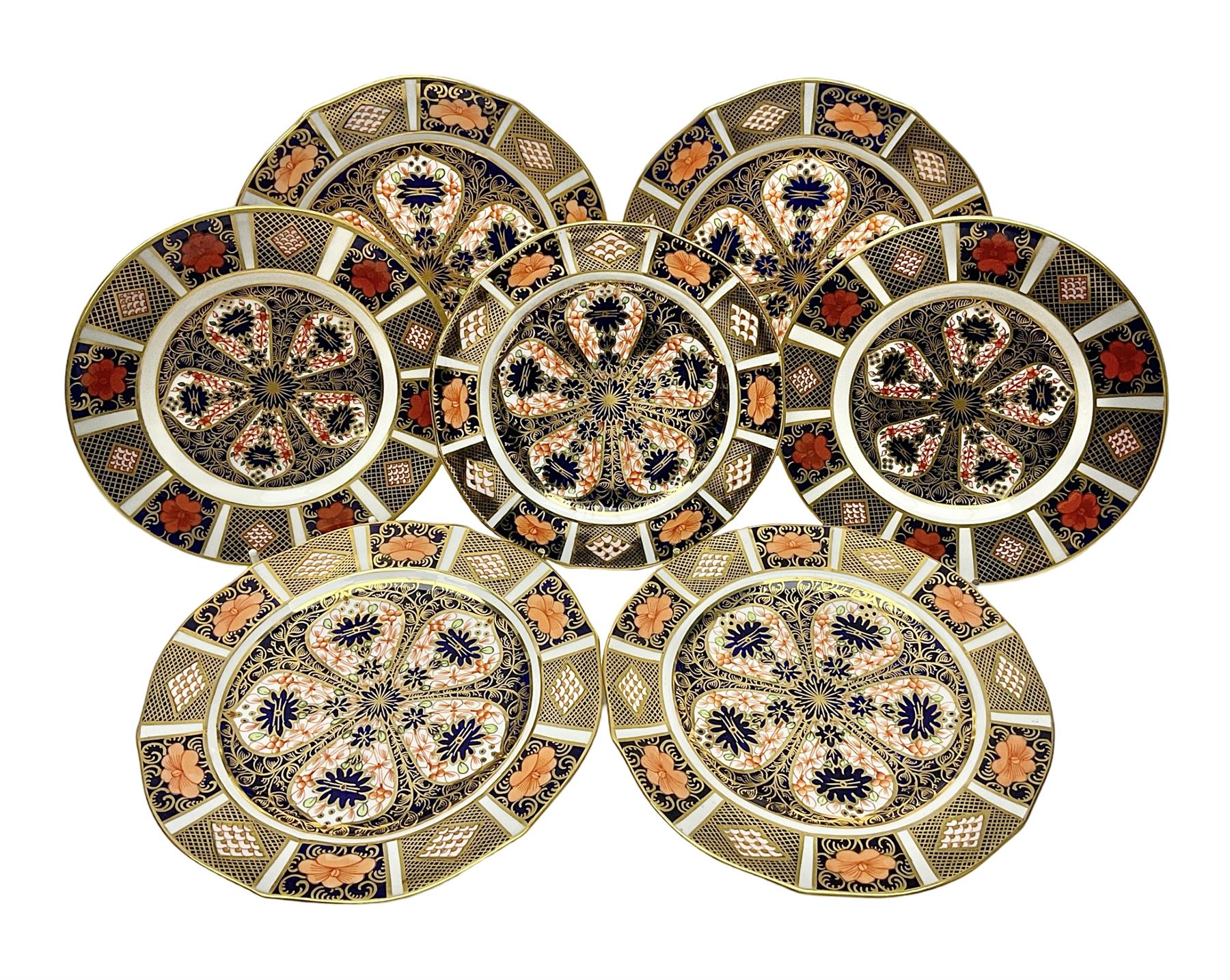 20th century Royal Crown Derby Imari 1128 pattern plates, comprising four side plates and three smaller examples, with printed and painted marks beneath, including illustration date codes for 1918 and 1920, and Roman numeral date code for 1979, larger examples D18cm, smaller D15cm, (7)
