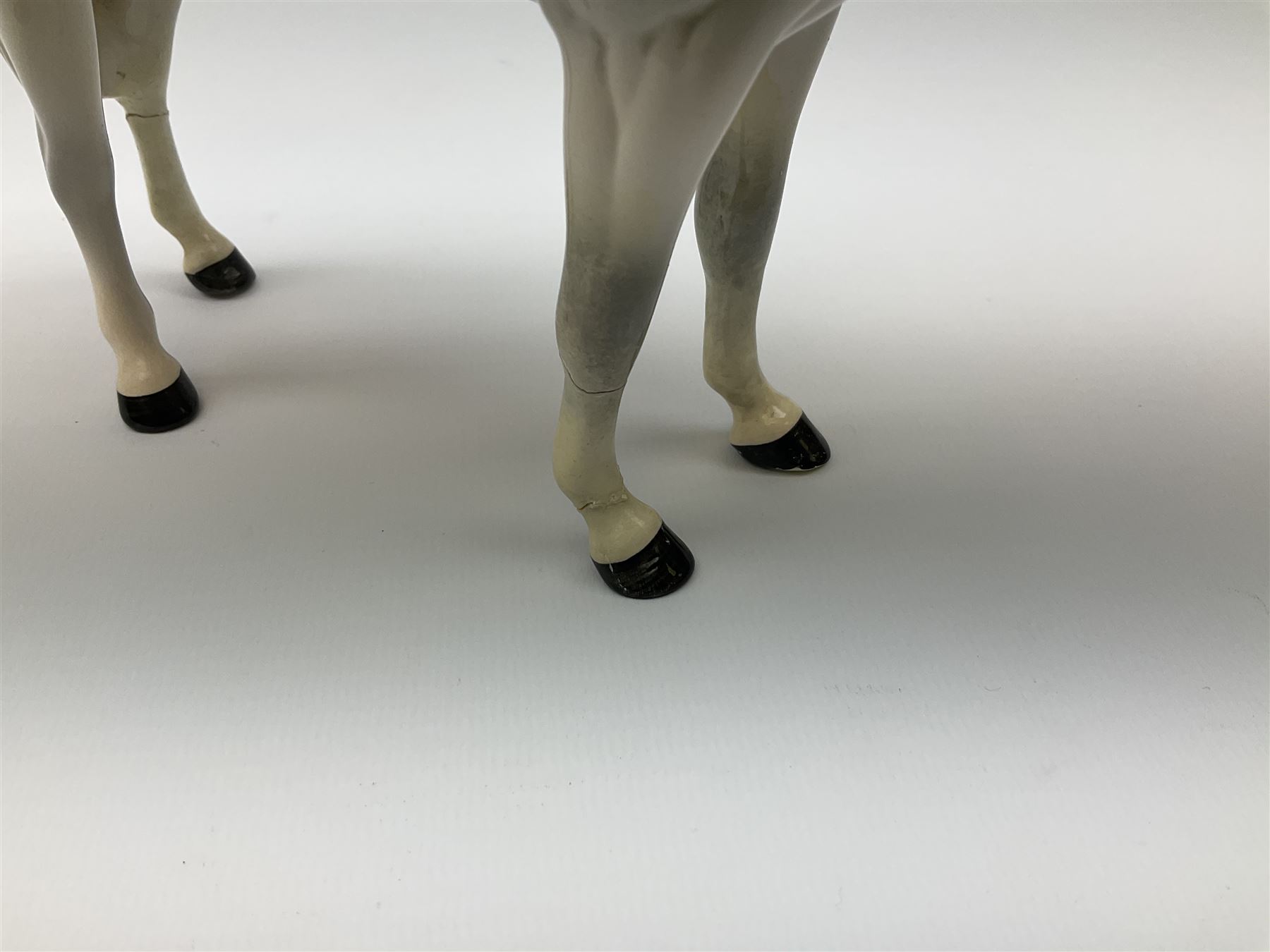 Beswick model of a huntswoman on grey horse model no 1730, and Beswick huntsman on brown horse model no 1501, both with printed mark beneath. 