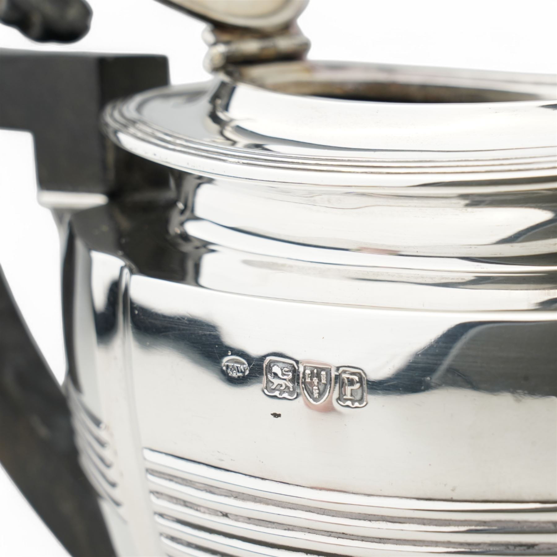 Late Victorian silver three piece tea set of panel sided oval design, the teapot with ebonised handle and lift, Chester 1898/99 Maker Florence Warden and William Aitken