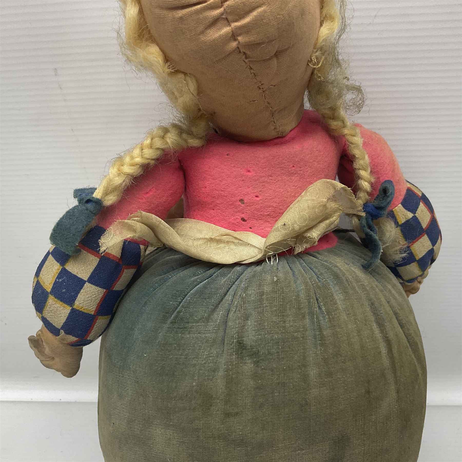 Farnell Alpha Toy soft toy of a Dutch girl, the pressed felt head with applied hair and painted features and overstuffed full length dress with apron and clogs; inoperative clockwork musical movement H31cm